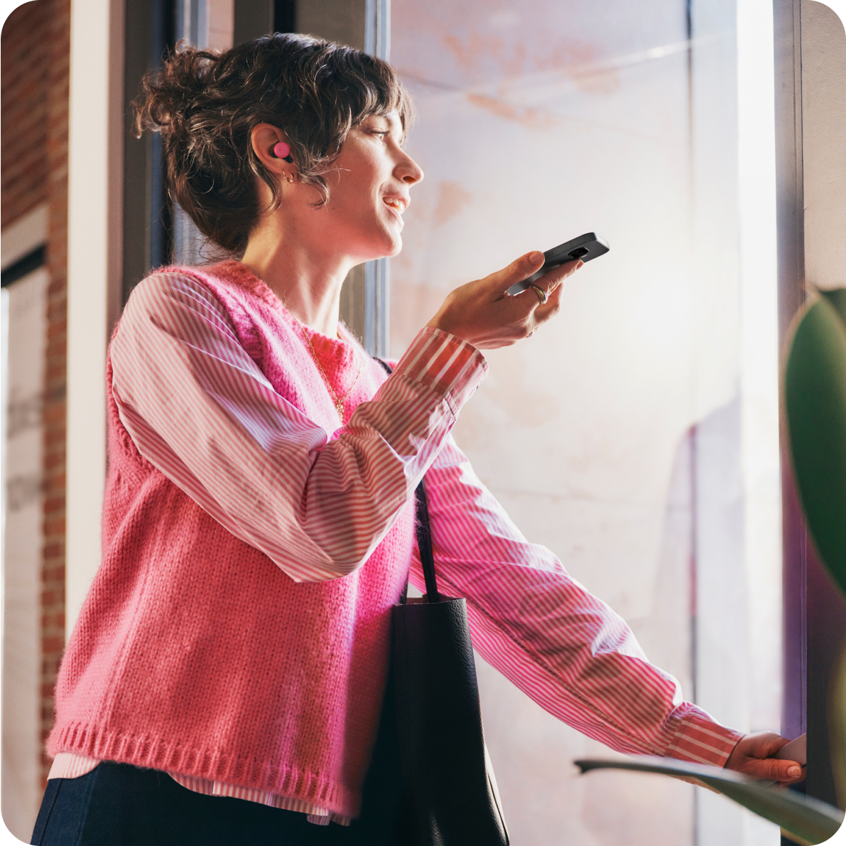 A woman using her Google Pixel 9a phone.