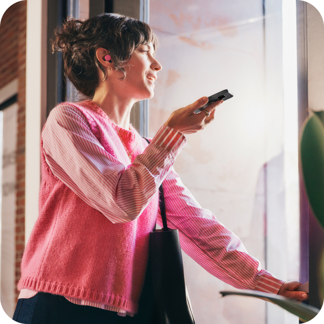 A woman using her Google Pixel 9a phone.