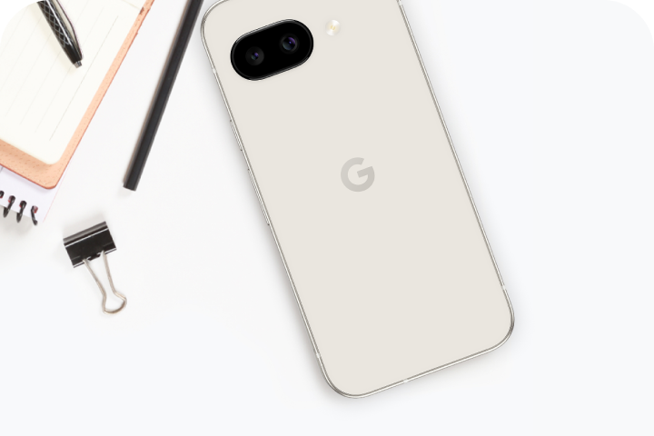 A Google Pixel 9a next to a pencil, notepad, and binder clip.