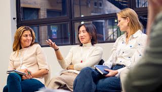 Three woman are discussing.