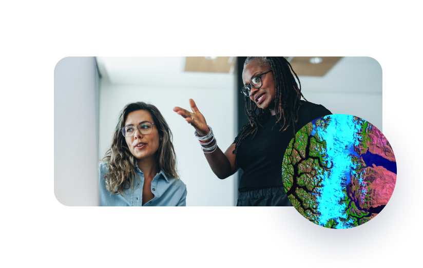 Two people referencing information with a satellite image overlay