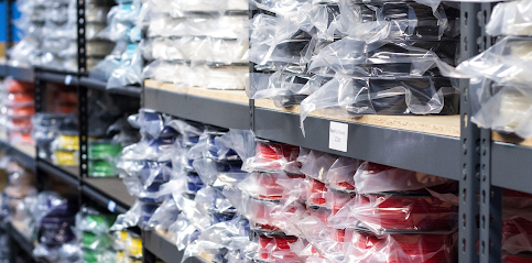 Many different types and colors of filaments sitting on warehouse shelves